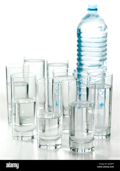 A bottle and eight glasses of water on a white background Stock Photo ...