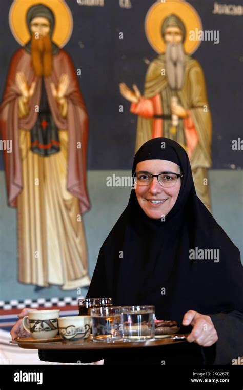 Nun offering coffee, raki and pastries to a visitor in Zica orthodox ...