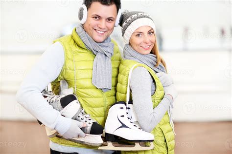 Cheerful couple in the skating rink 15895546 Stock Photo at Vecteezy