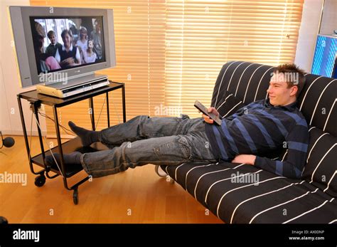 Teenager sitting on couch watching TV Stock Photo, Royalty Free Image: 16688145 - Alamy