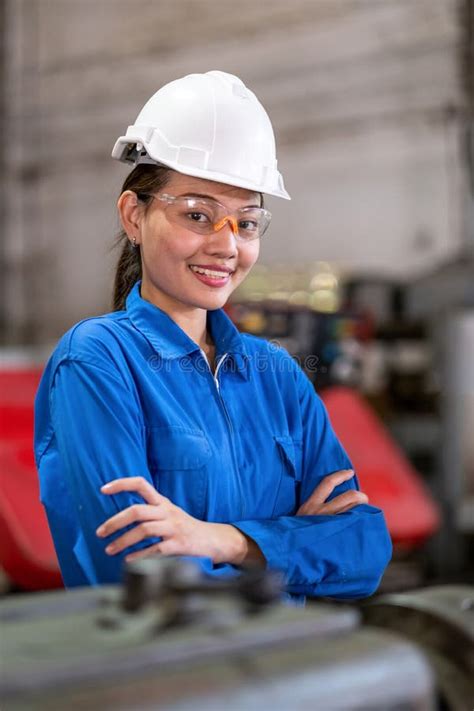 Portrait of Engineer Woman Crossed Arm and Smile in the Smart Factory. Welding Robotic Automatic ...