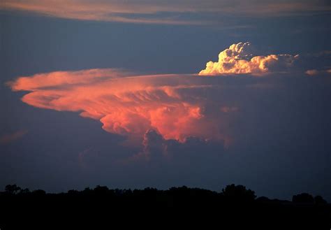 A distant view of a supercell thunderstorm (cumulonimbus)cloud with a large "overshooting top ...