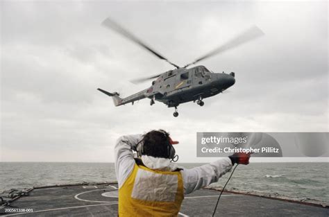 UK, Irish Sea Helicopter lifting off warship, navigator giving... News Photo - Getty Images