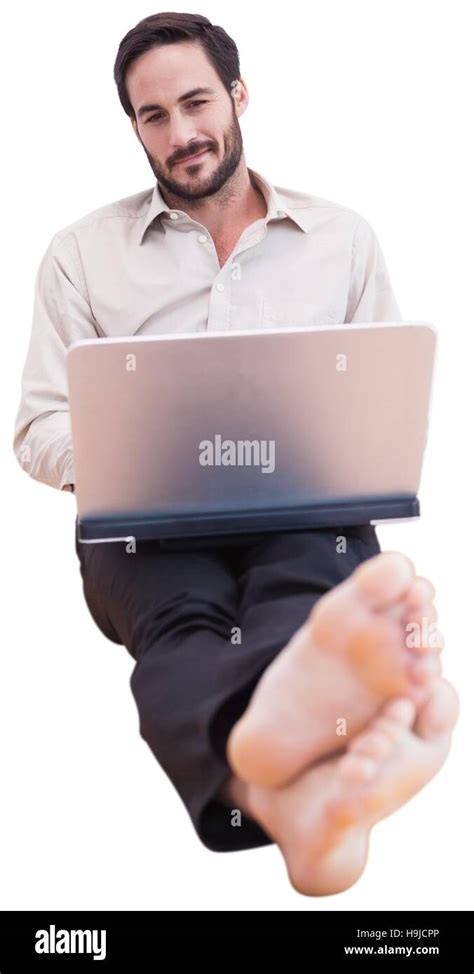 Smiling man using a laptop Stock Photo - Alamy