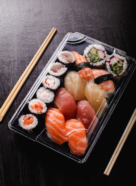 Premium Photo | Sushi to go concept. takeaway box with sushi