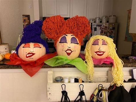 three pumpkins that have been carved to look like clowns are sitting on a counter