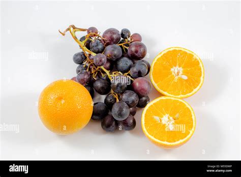 Grapes and oranges in a white background/fruits/orange/fresh/grapes Stock Photo - Alamy