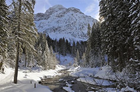 Beautiful Valley In Winter - Snowy Trees River And Mountains Photograph by Matthias Hauser