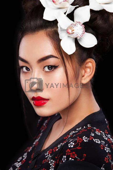 Studio fashion shot of Asian woman with white flower in hair by MikeOrlov Vectors ...