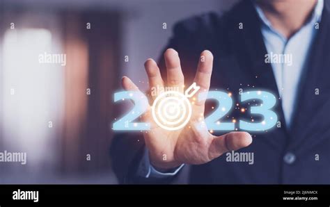 business target and goal on New year 2023 concept, hand holding 2023 virtual screen. new years ...