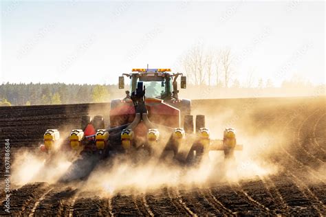 Tractor plowing field at sunny day Stock Photo | Adobe Stock