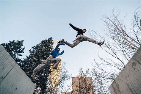 "Two Men Jumping During A Parkour Training At Sunset" by Stocksy ...