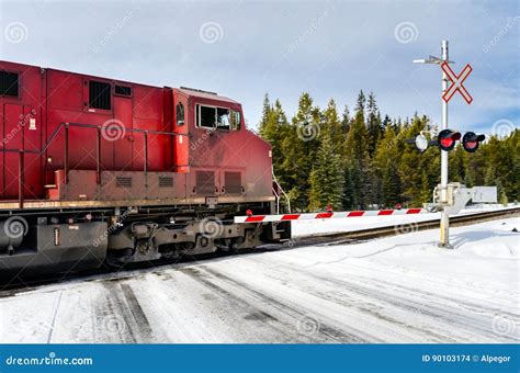 Cargo Train at a Snow Covered Railroad Crossing Stock Photo - Image of level, cargo: 90103174