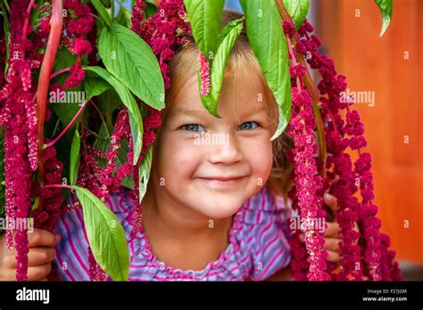 little girl smiling in pink flowers Stock Photo - Alamy