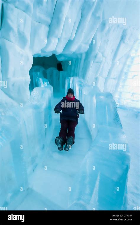 Woman slides down the ice slide, Hotel de Glace, Ice Hotel, Quebec City ...