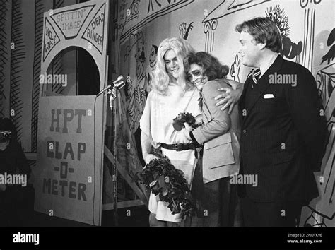 Actress Faye Dunaway embraces Joe Kiely, left, of Atlanta, Ga ...