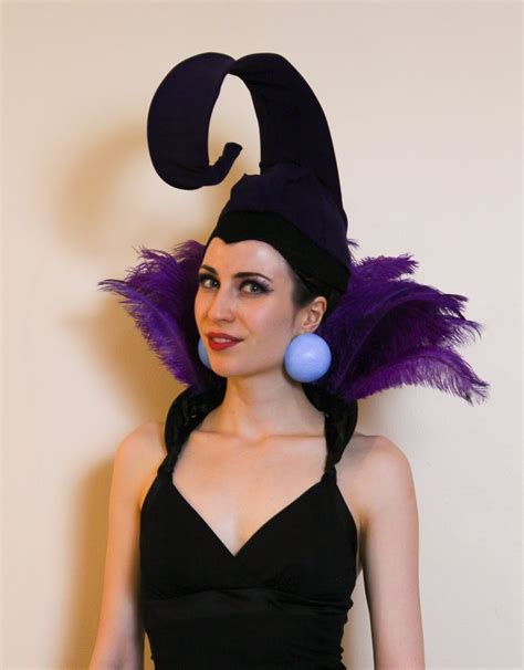 Woman dressed as Yzma from Emperor's New Groove, with large curled hat ...