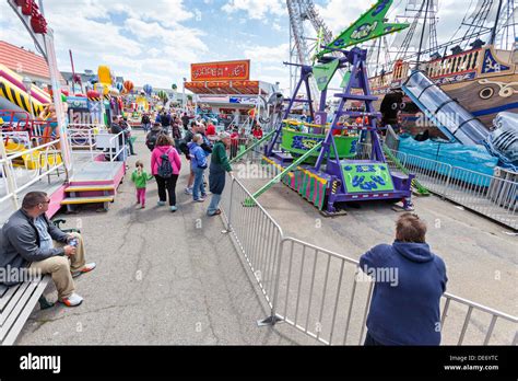 Children and parents enjoy the amusement park rides Stock Photo - Alamy