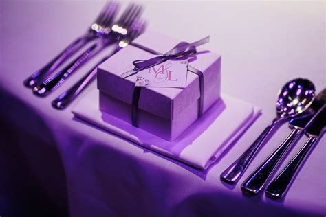 a table set with silverware, forks and a gift box on top of it