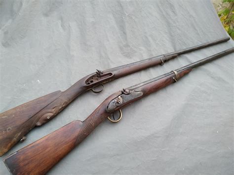 Two old shotguns from early 1800's, the one in the front is prussian the lock plate has the ...