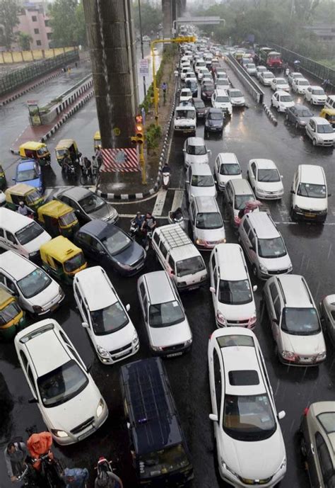 PHOTOS: Early morning rains lash Delhi: Traffic jams, waterlogging halt ...