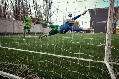 Soccer football goalkeeper making diving save | Stock image | Colourbox