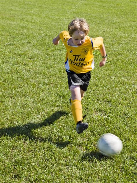 Boy playing soccer Stock Photo by ©kozzi2 19970079