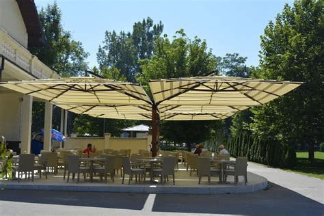 an outdoor dining area with tables and umbrellas