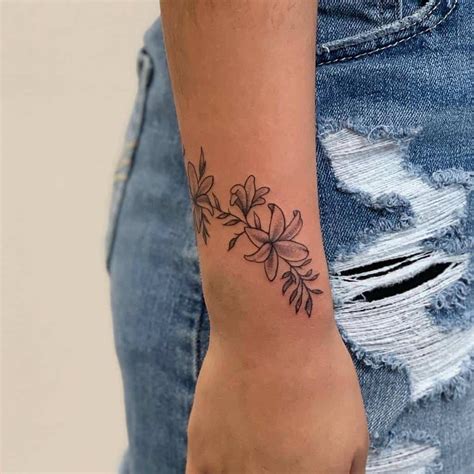 Aggregate 136+ flower wrist tattoos for females - vova.edu.vn