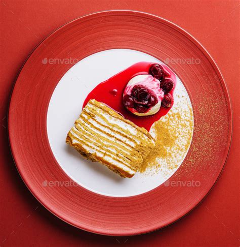 Napoleon cake with vanilla ice cream with cherry jam Stock Photo by ...