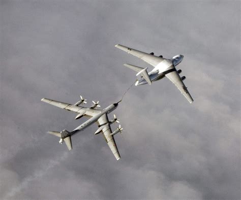 A Russian Tupolev Tu-95 strategic bomber refuels from Il-78 tanker over ...