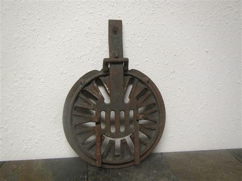 an old cast iron grate on the floor in front of a white wall and tile floor