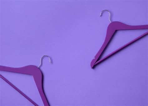 Premium Photo | Creative flat lay violet wooden hangers at purple table with copy space.