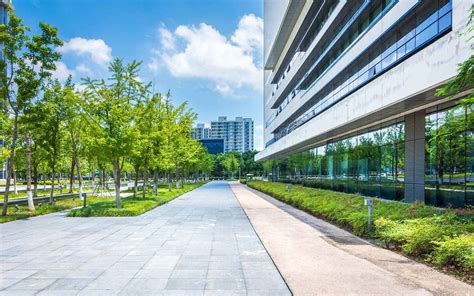 Outside of an office building with green landscaping - Varsity Inc