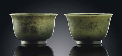 A PAIR OF SPINACH-GREEN JADE CUPS , QIANLONG INCISED SIX-CHARACTER SEAL ...