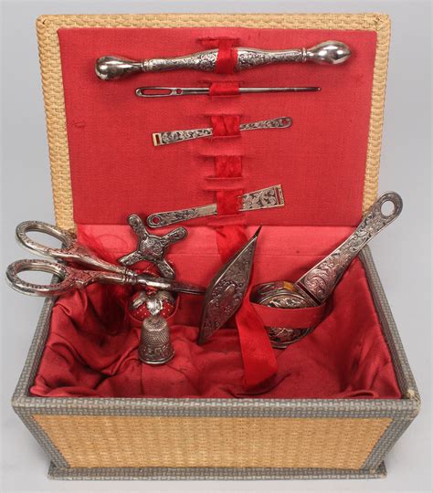 Lot 608: Box of antique sterling silver sewing accessories