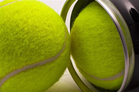 Yellow tennis balls out of black container | Two tennis ball… | Flickr