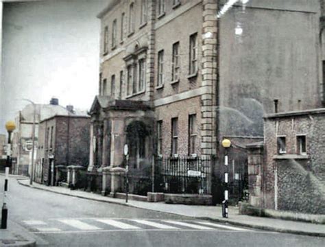 an old photo of a city street with buildings