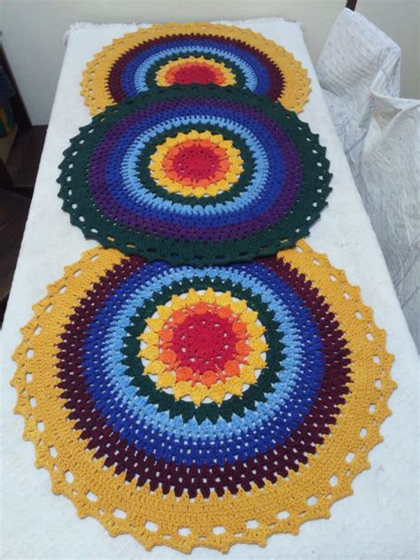 three crocheted circles on a white table cloth