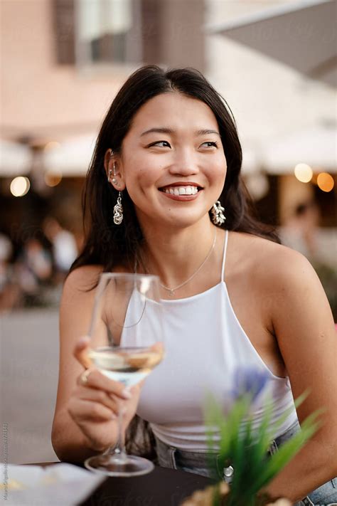 "A Smiling Woman Drinks Wine At The Bar And Have Fun" by Stocksy ...