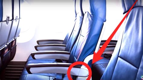 This Hidden Button Gives You More Room in a Plane's Aisle Seat | Mental Floss