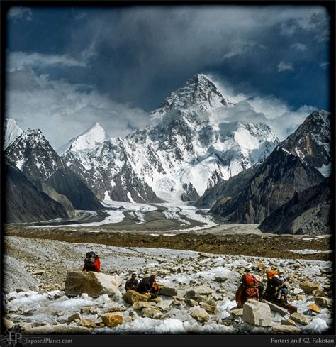 Porters on Baltoro Glacier with K2 in back, stock photography by