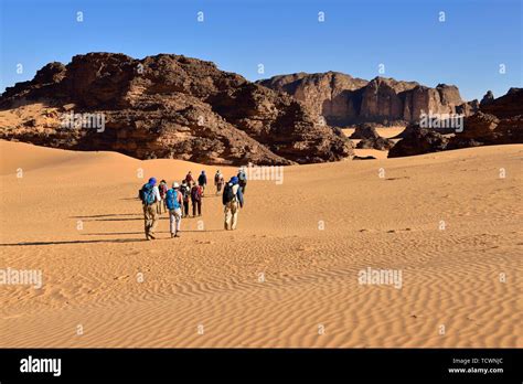 Group of people hiking in Tehouak, Tassili n'Ajjer National Park ...