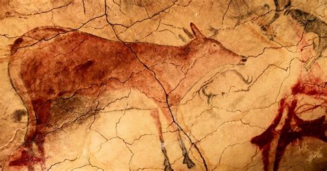 an animal painted on the side of a wall with red streaks in it's body