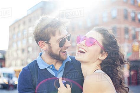 Couple laughing together outdoors - Stock Photo - Dissolve