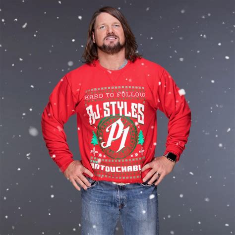 a man with long hair and beard wearing a red sweater in front of snowflakes