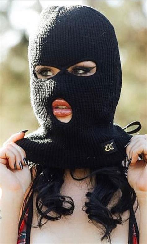 a woman wearing a black ski mask with her mouth open