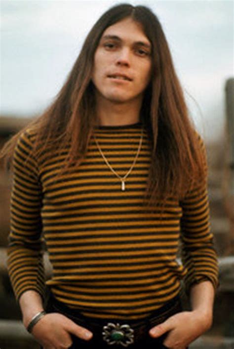 a woman with long hair wearing a striped shirt