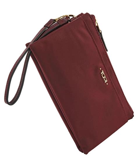 From our stylish Voyageur collection comes this slim wristlet, trimmed with… | Tumi, Voyageurs ...