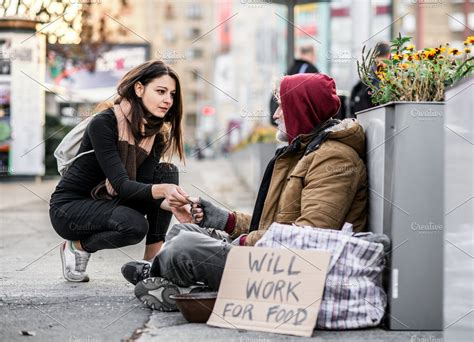 Young woman giving money to homeless | High-Quality People Images ~ Creative Market